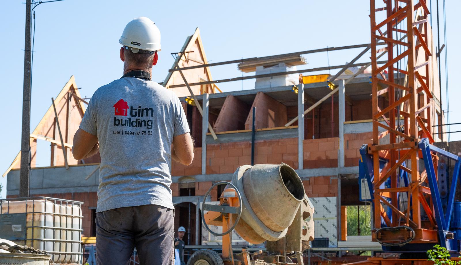 Metser van Tim Building op een ruwbouwwerf